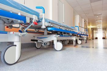 hospital beds lined up in a corridor