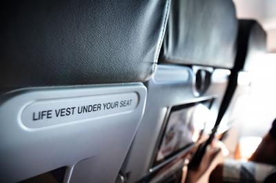 Back of aircraft seat showing the words: Life vest under your seat