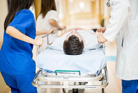 Patient being wheeled on hospital bed