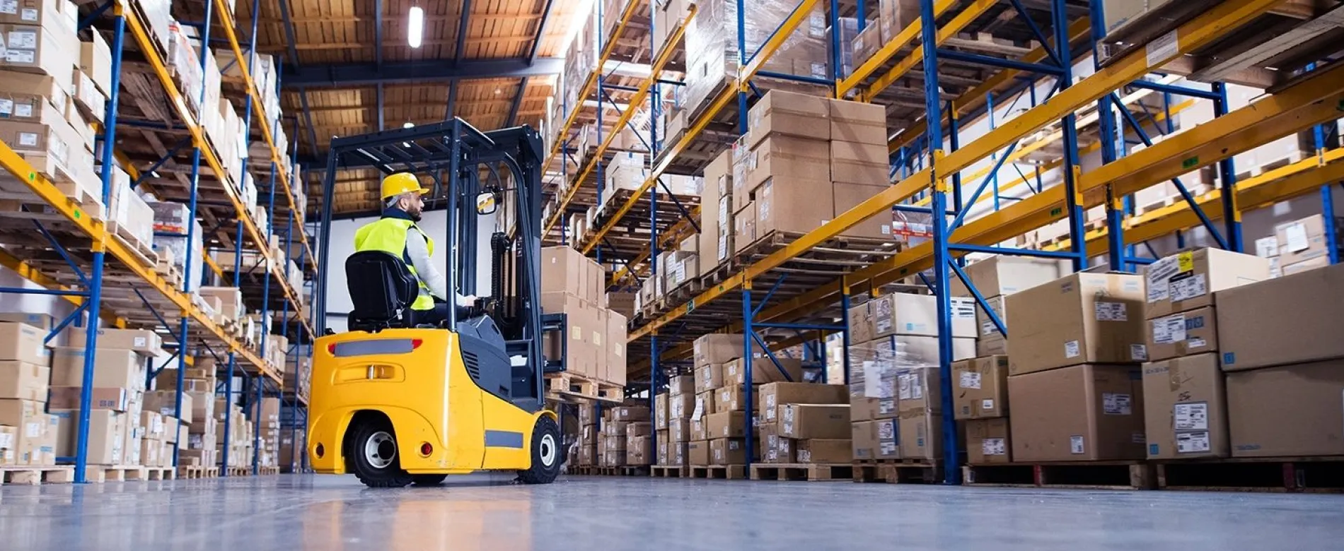 Forklift lifting pallet in warehouse