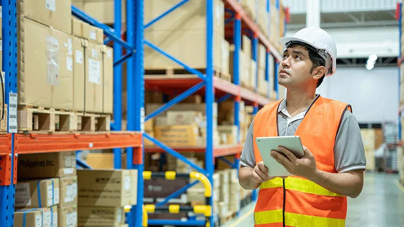 worker in warehouse with tablet