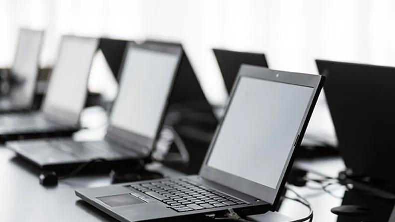 Multiple laptops open and plugged in