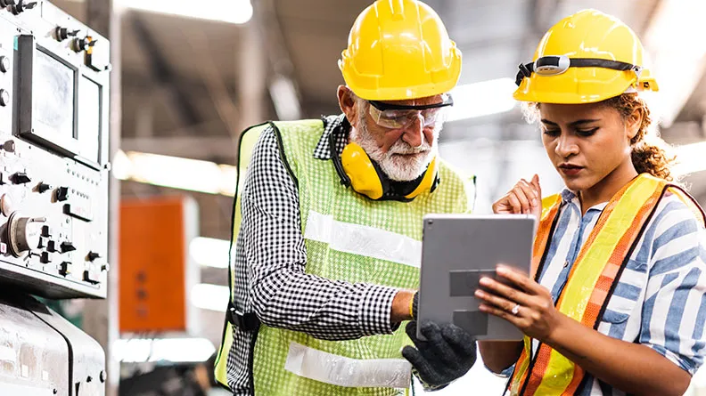 Workers looking at a tablet