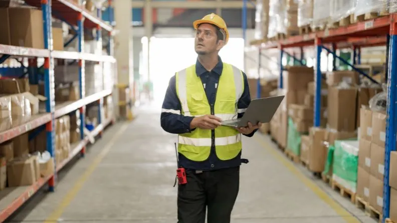 worker in a warehouse using tracking system