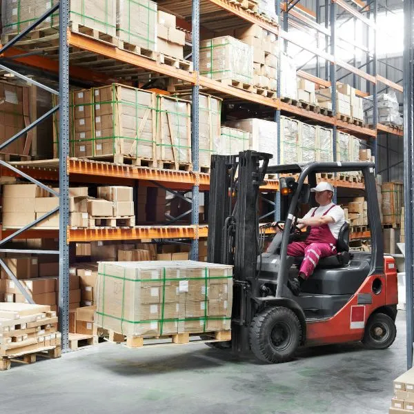 worker using a forklift in a warehouse